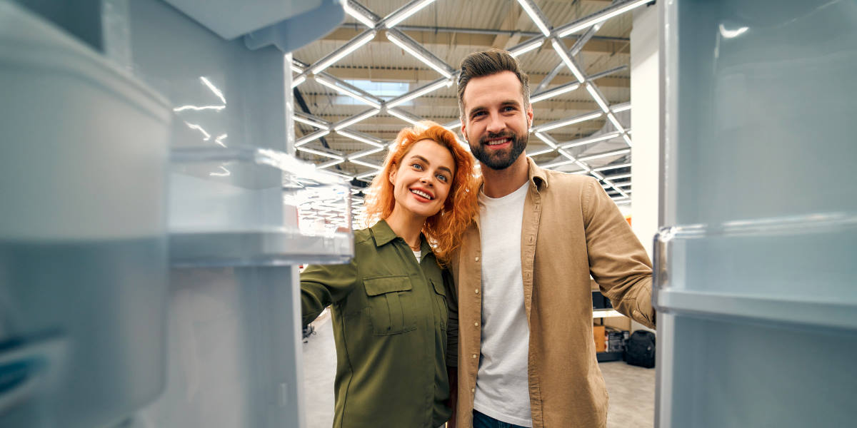 Couple shopping for a fridge freezer