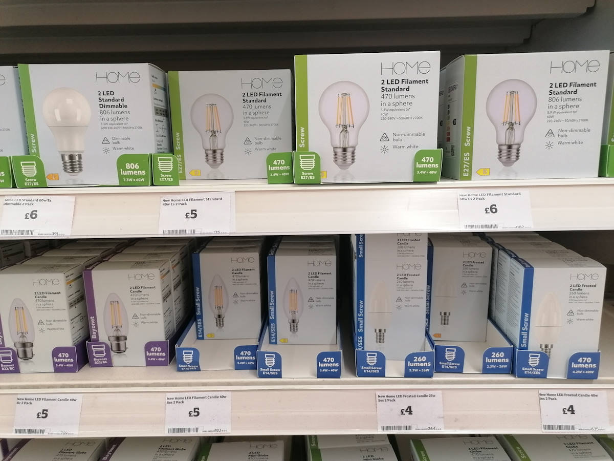 Different types of LED light bulbs on a shop shelf.