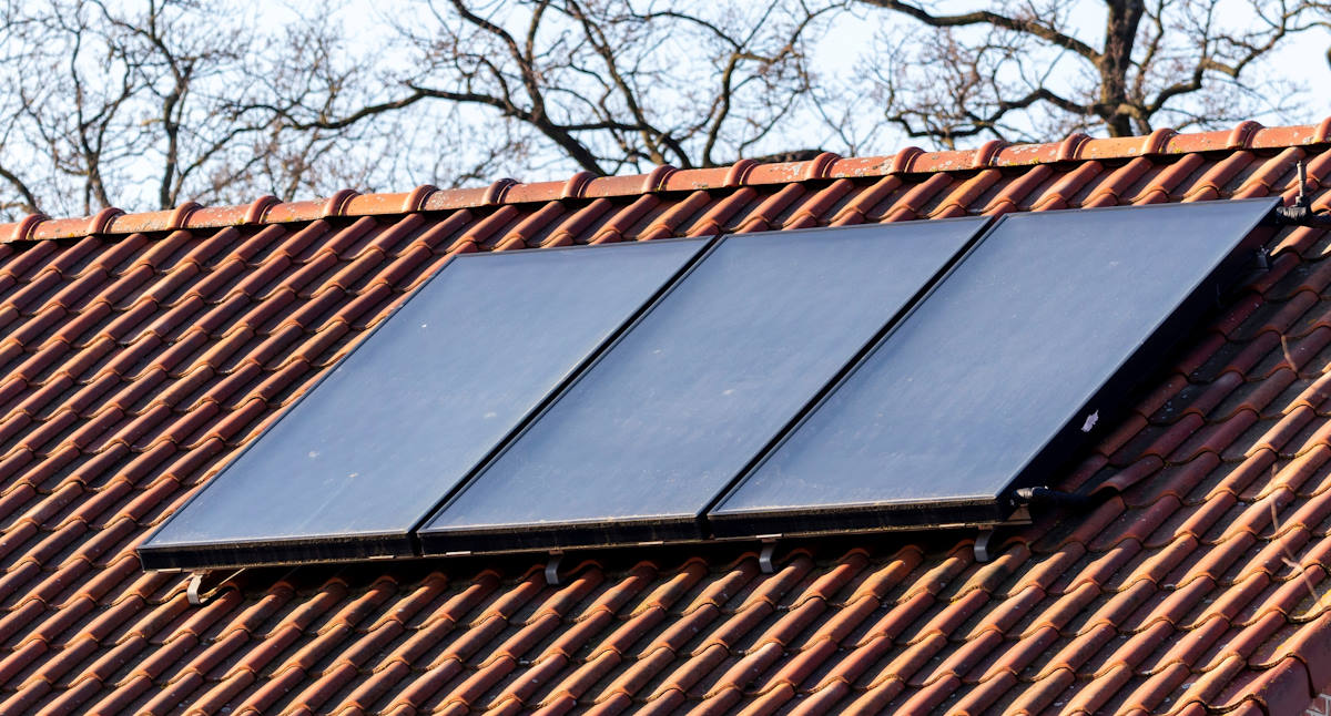 Solar thermal collector panels on a residential roof.