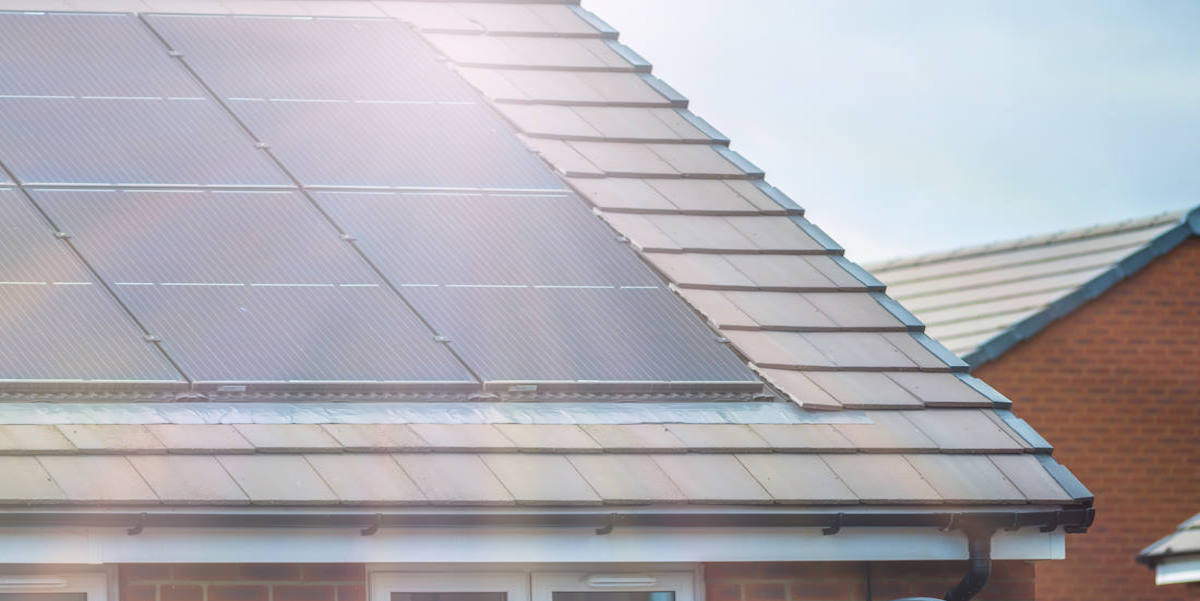Sun shining on roof mounted solar panels.